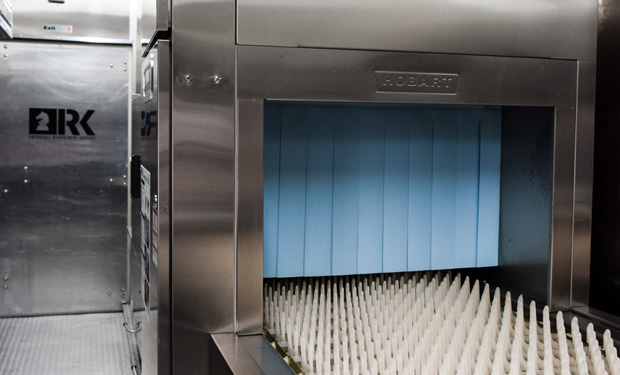 Close of up of an industrial dishwasher in a dishwashing trailer