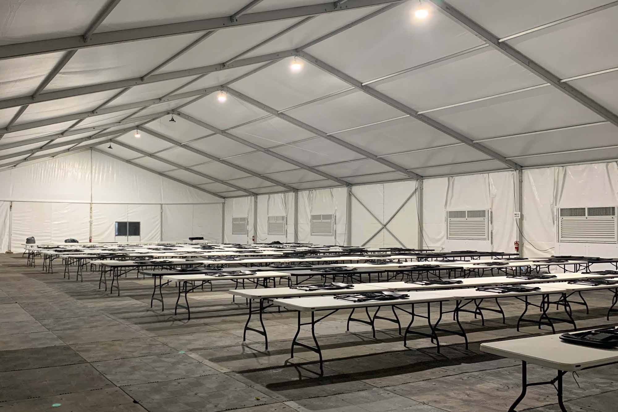 Large dining area inside of a tent. 