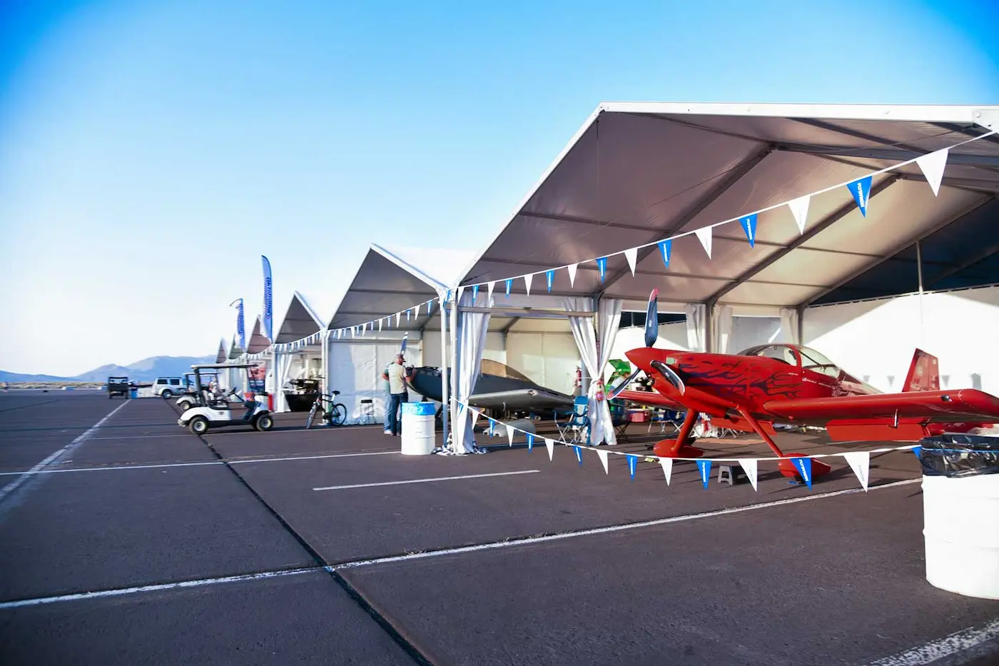 Airplane show with small airplanes inside of tents