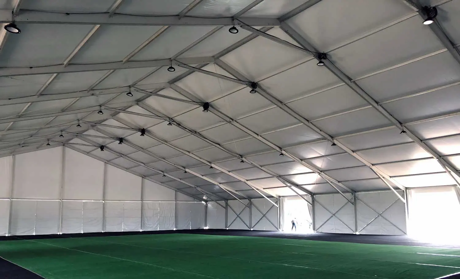 Large empty tent with green carpet