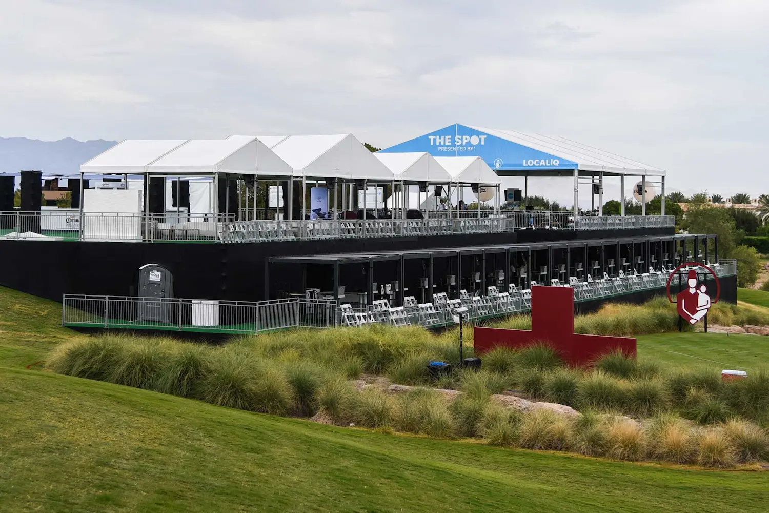 Tents overlooking a golf tournament
