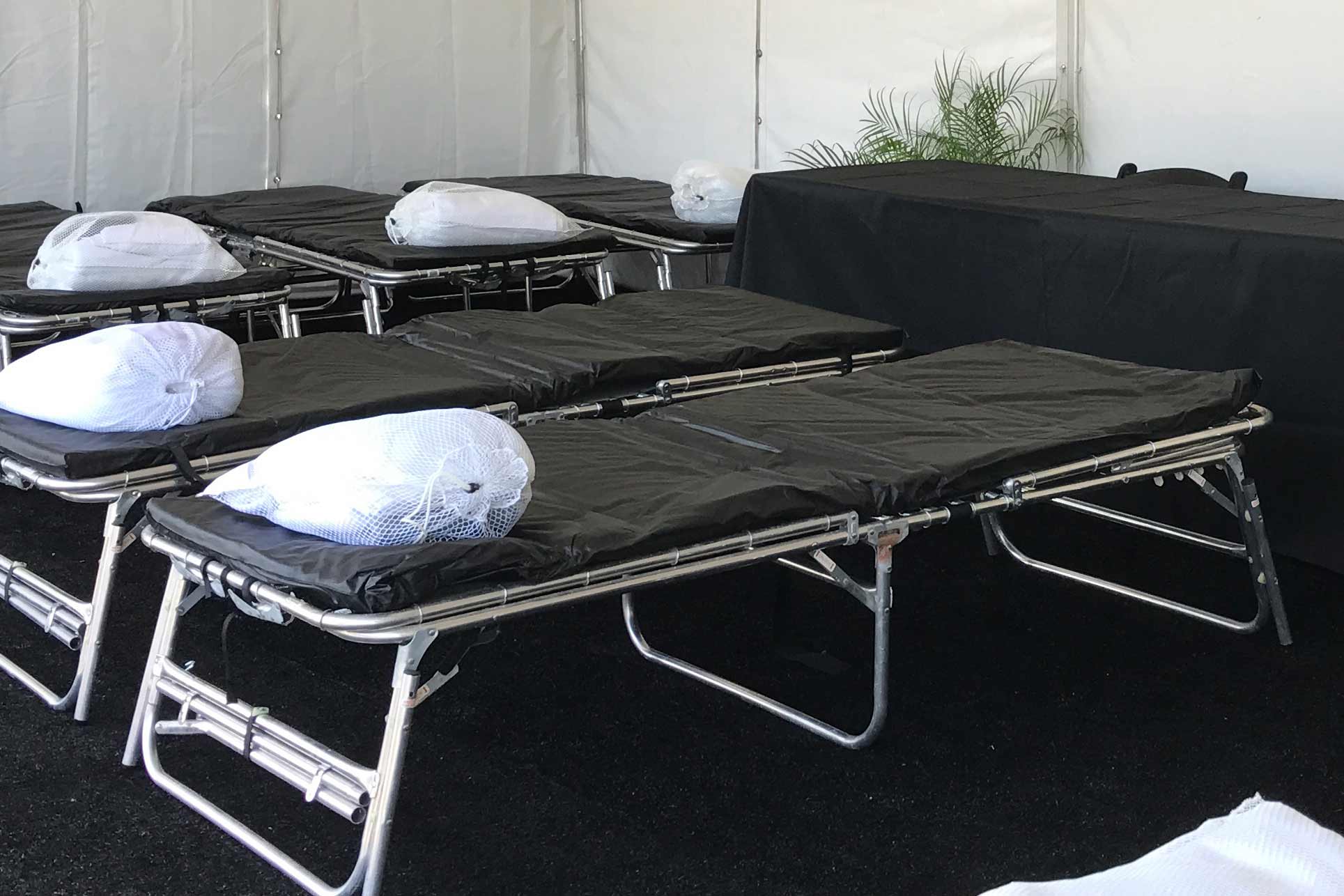 Cots inside a temporary structure for disaster relief
