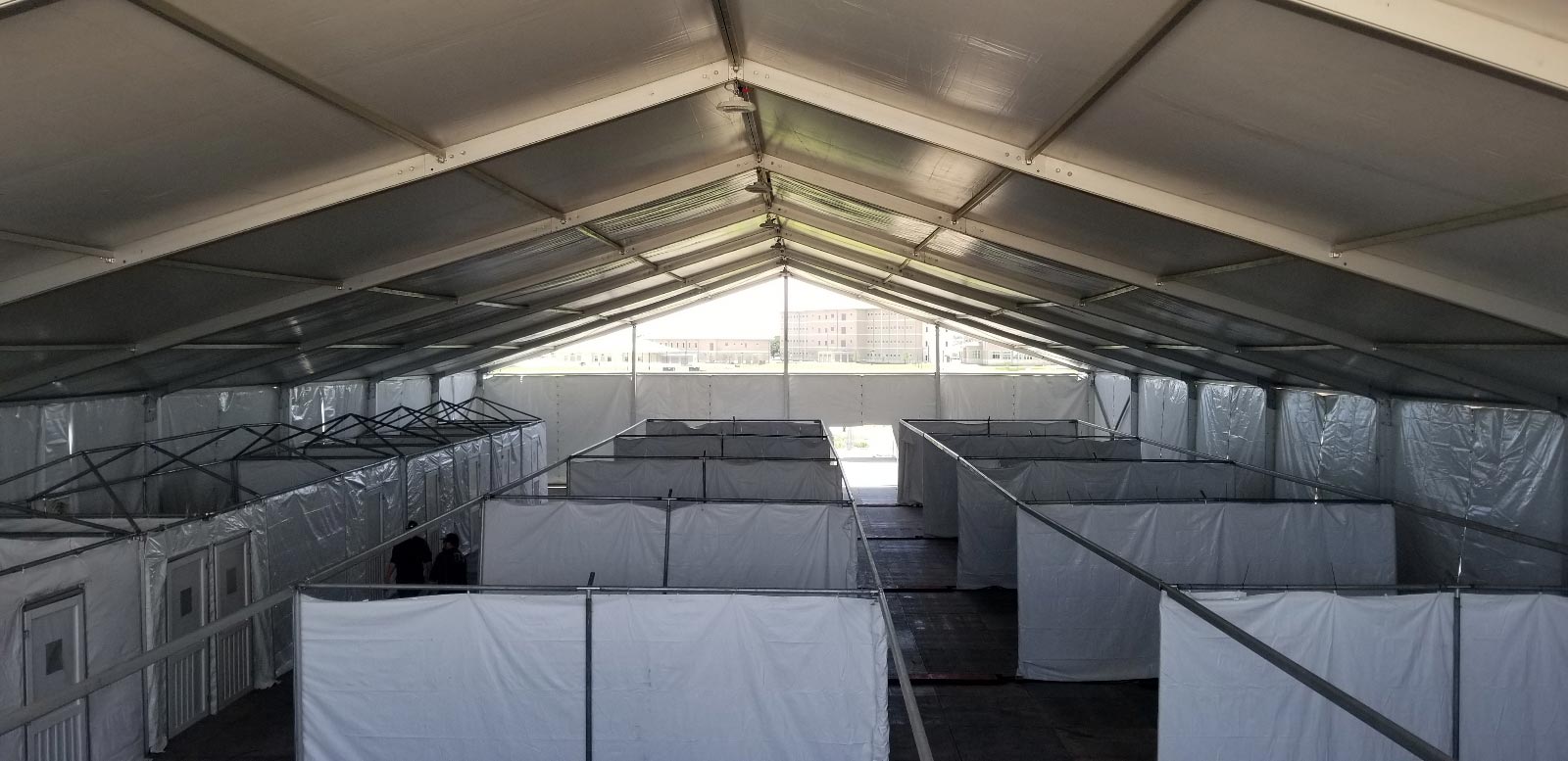 Temporary housing spaces inside a large tent for disaster relief