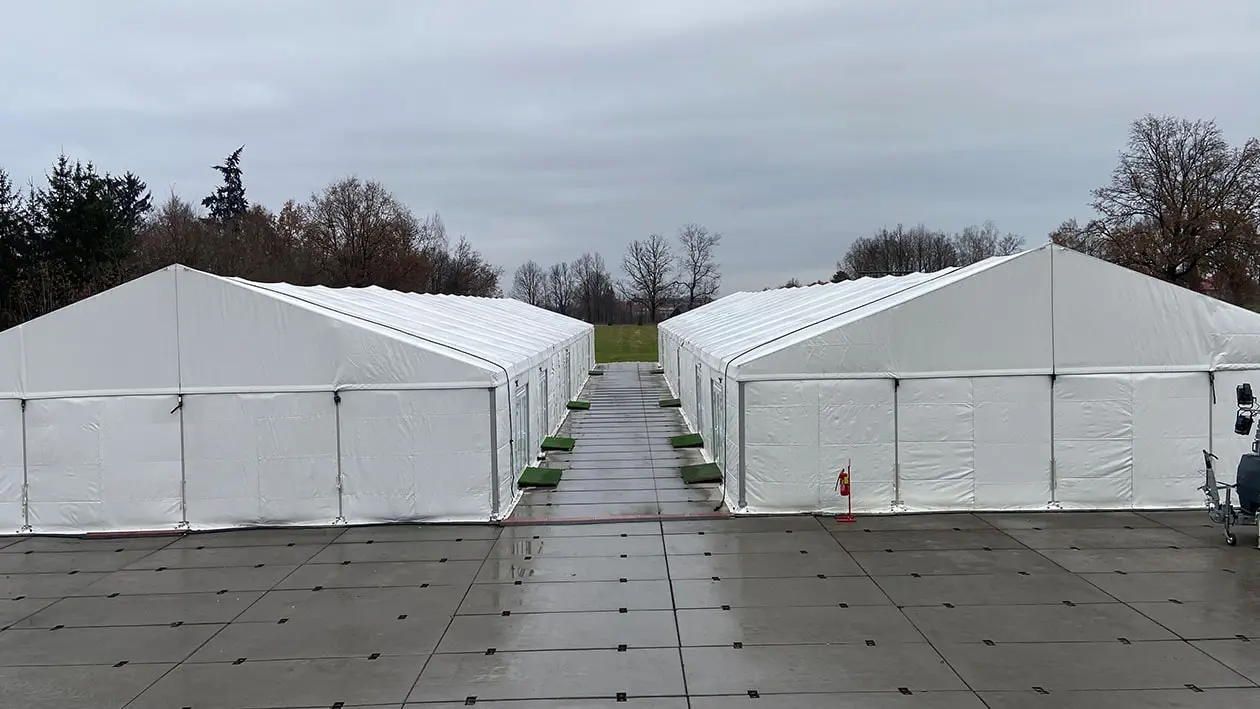 Two tents set up on large concrete pad
