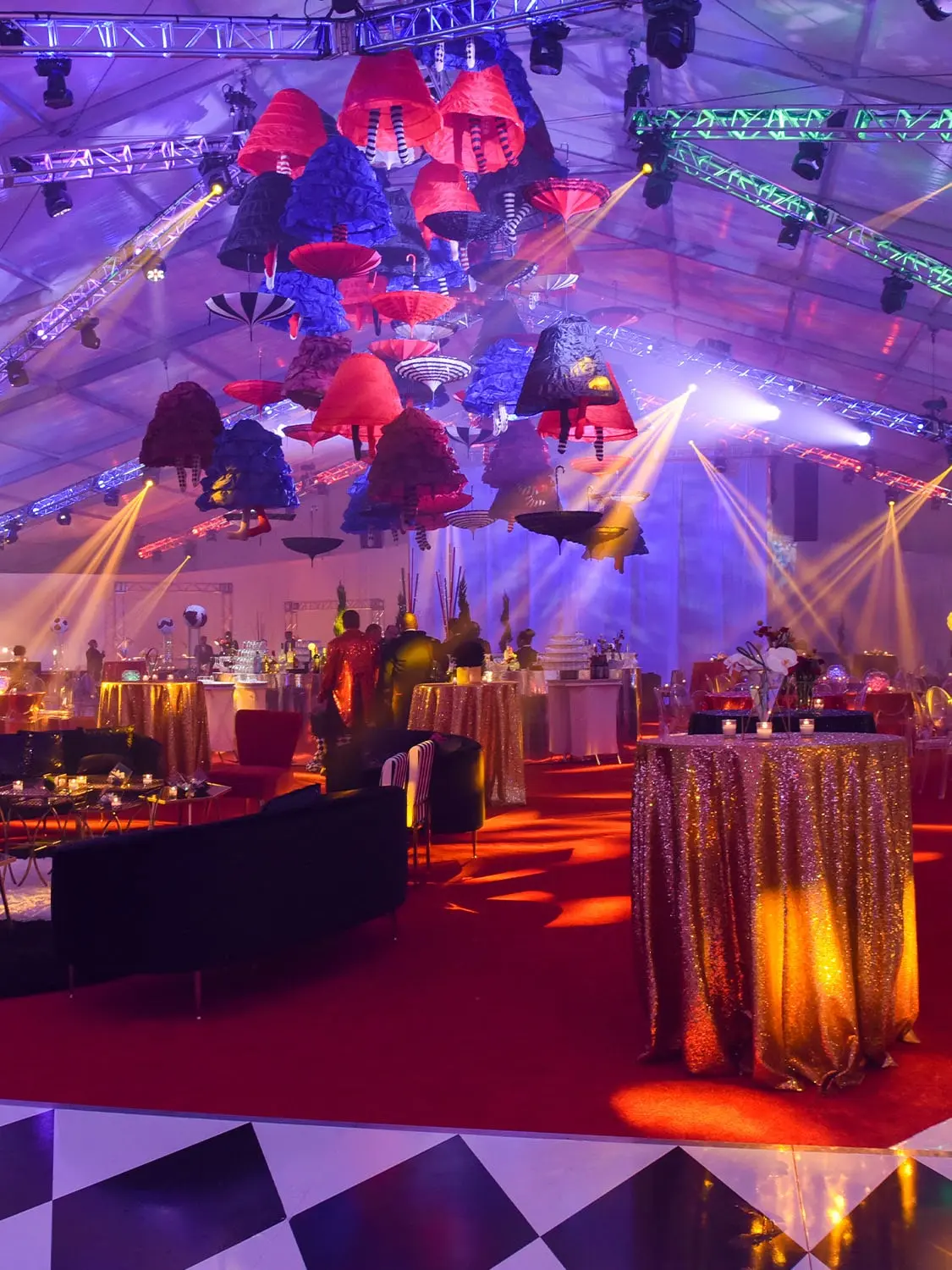 Magical Circus Ball, large tent with tables and decor set up and spot lights