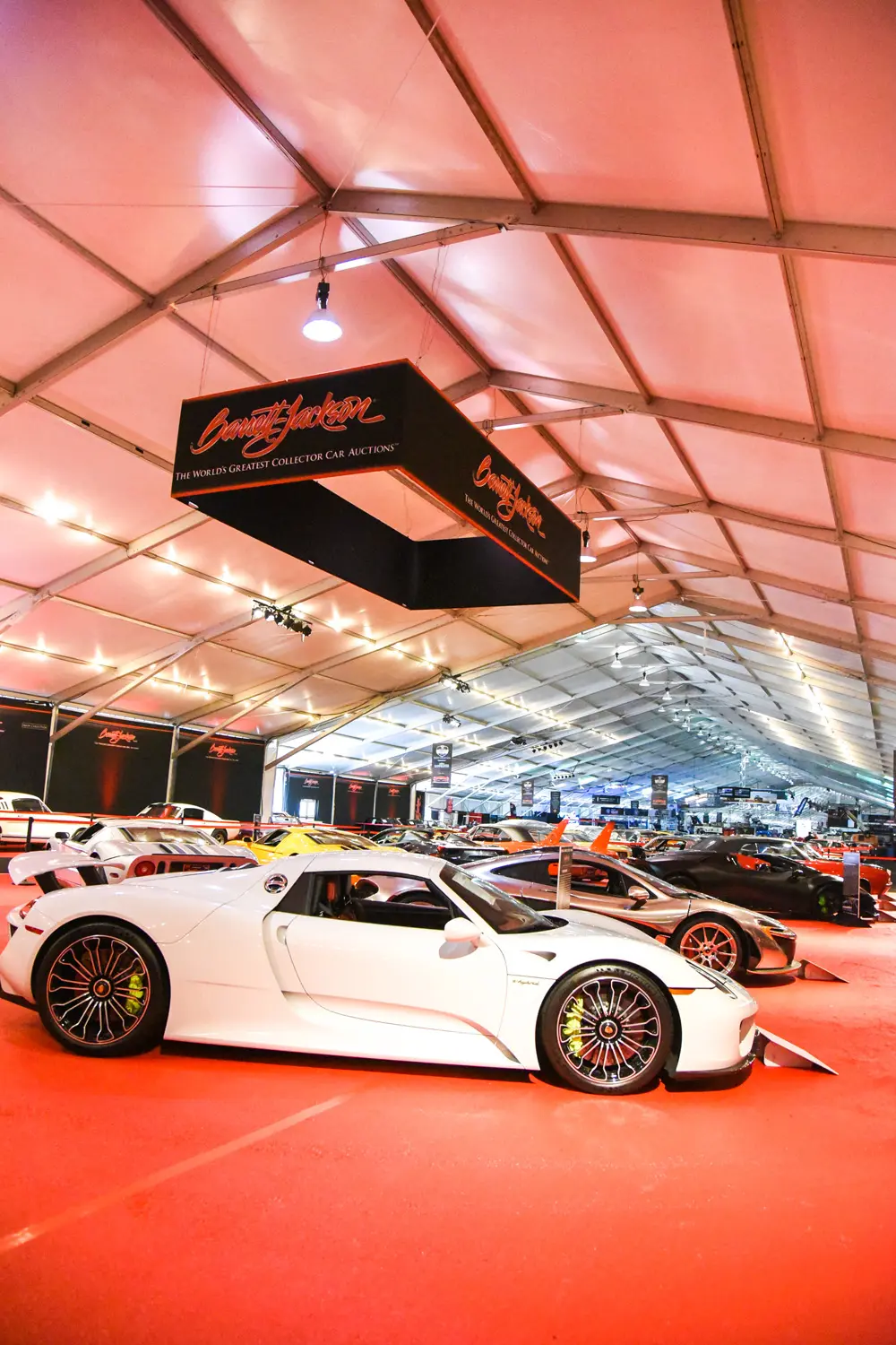 Car expo with luxury cars in a large tent