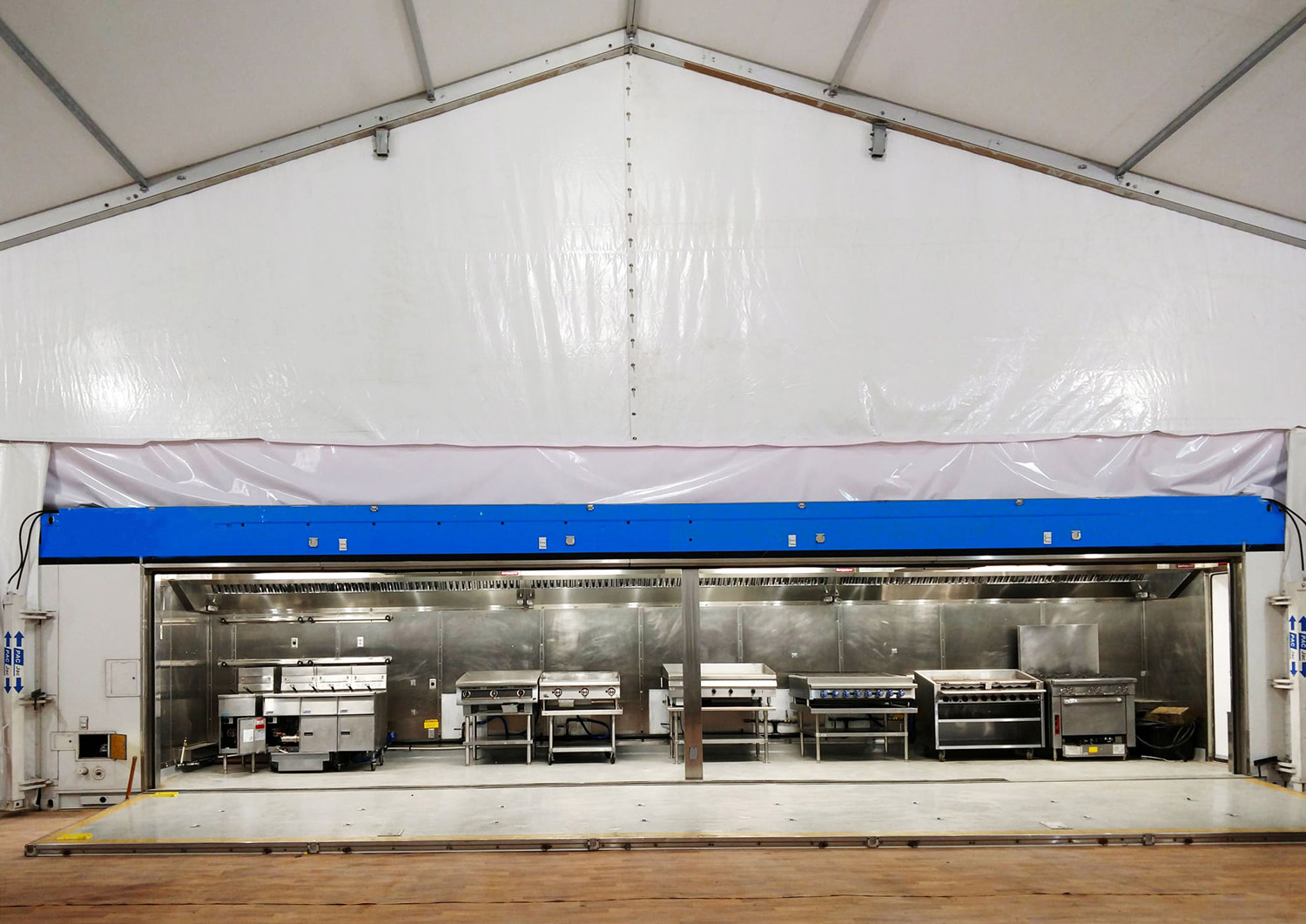Mobile kitchen trailer connected to a tent